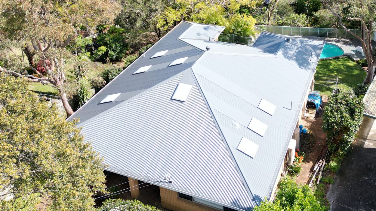 Aerial view of a house in Sydney with a large corrugated metal roof installed by Professional Metal Roofing Contractors