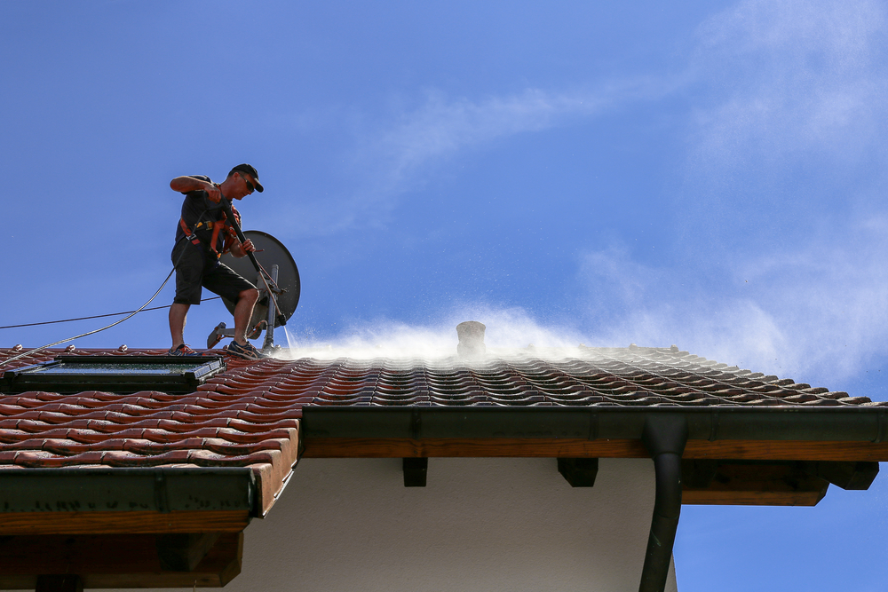 Soft wash roof cleaning to eliminate moss on roof without damaging tiles